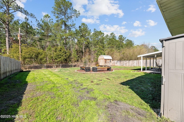 view of yard featuring an outdoor structure, a fenced backyard, and a storage shed