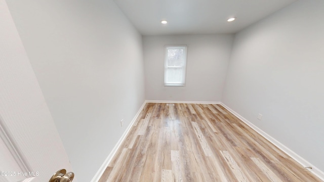 unfurnished room with recessed lighting, light wood-style flooring, and baseboards