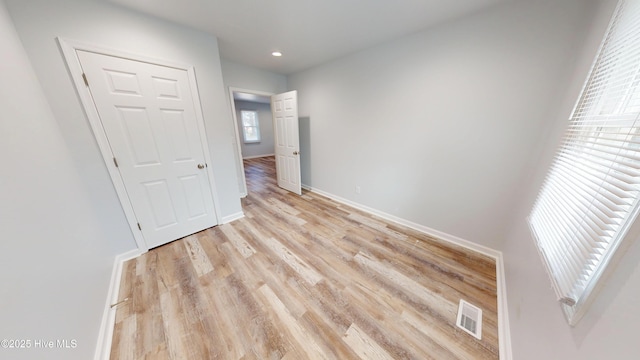 unfurnished bedroom with light wood-type flooring, visible vents, baseboards, and recessed lighting