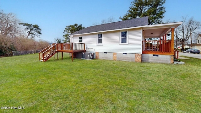 rear view of property with a shingled roof, stairway, central AC, a lawn, and crawl space