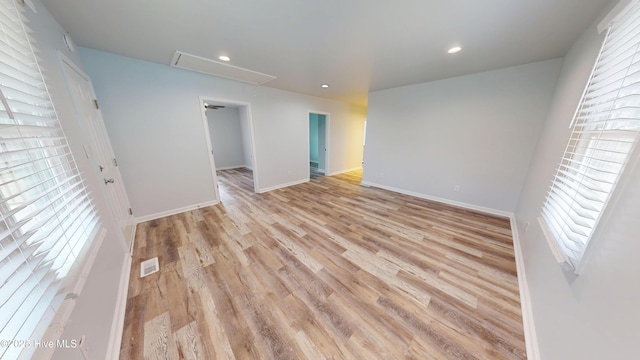 unfurnished room featuring visible vents, baseboards, attic access, recessed lighting, and light wood-style floors