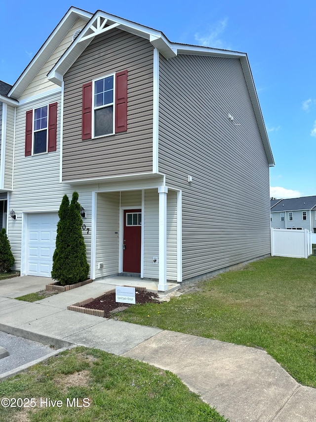 view of front facade featuring fence, a front lawn, and a garage