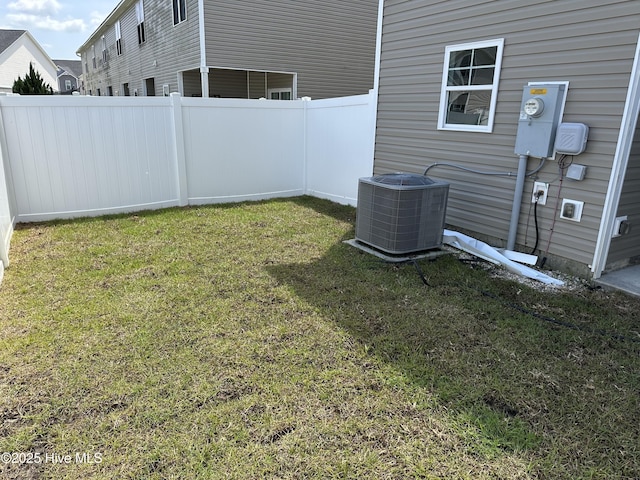 view of yard featuring central air condition unit and fence