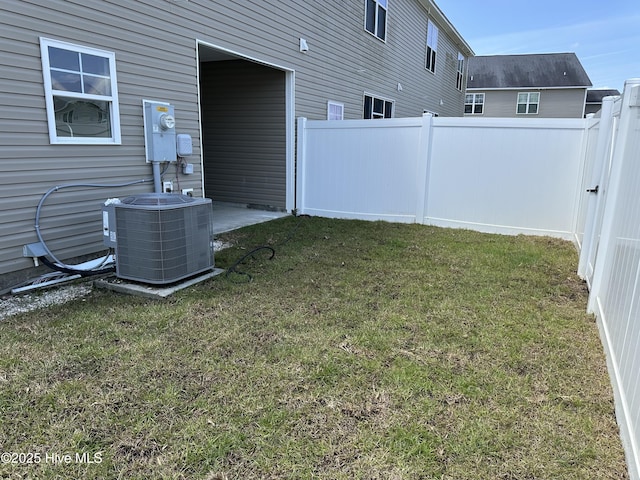 view of yard featuring central air condition unit and fence