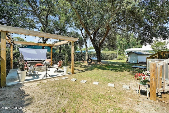 view of yard featuring a fire pit, an outbuilding, a patio, and a shed