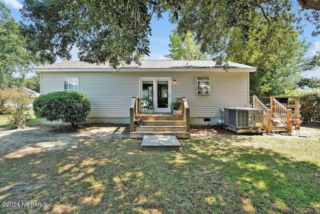 rear view of house with crawl space, a lawn, central AC unit, and a deck