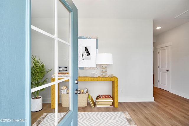 corridor with recessed lighting, baseboards, and wood finished floors