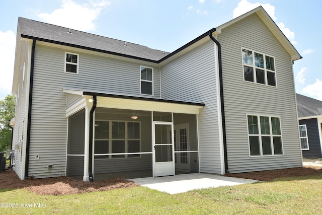 rear view of house featuring central AC unit, a yard, a patio area, and a sunroom