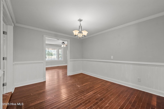 unfurnished room with a wainscoted wall, ornamental molding, ceiling fan with notable chandelier, and hardwood / wood-style flooring