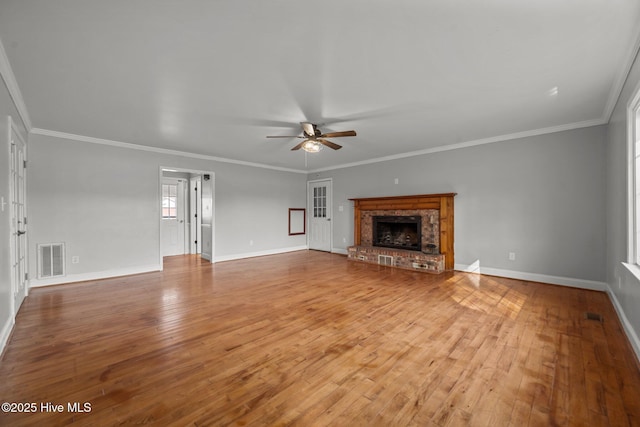 unfurnished living room featuring light wood finished floors, visible vents, baseboards, a fireplace, and a ceiling fan