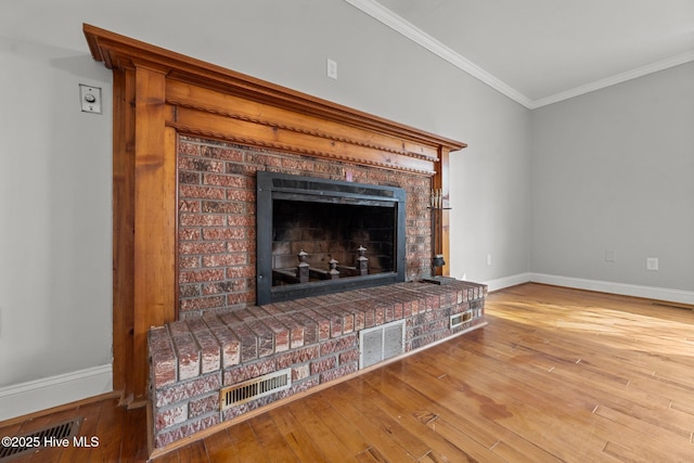 room details with crown molding, wood finished floors, a fireplace, and baseboards