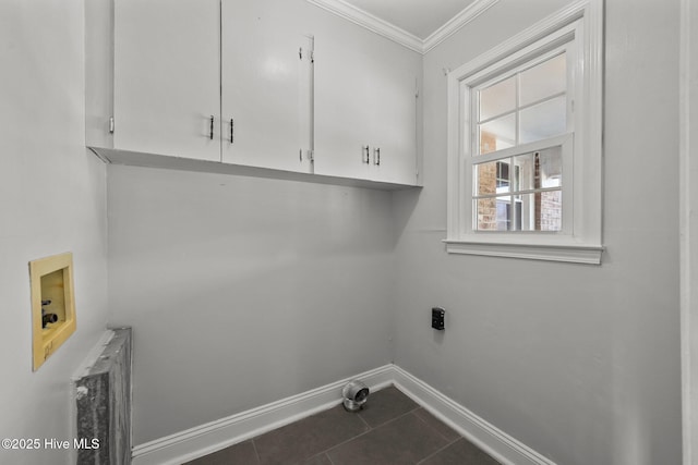 washroom with cabinet space, electric dryer hookup, washer hookup, crown molding, and dark tile patterned floors