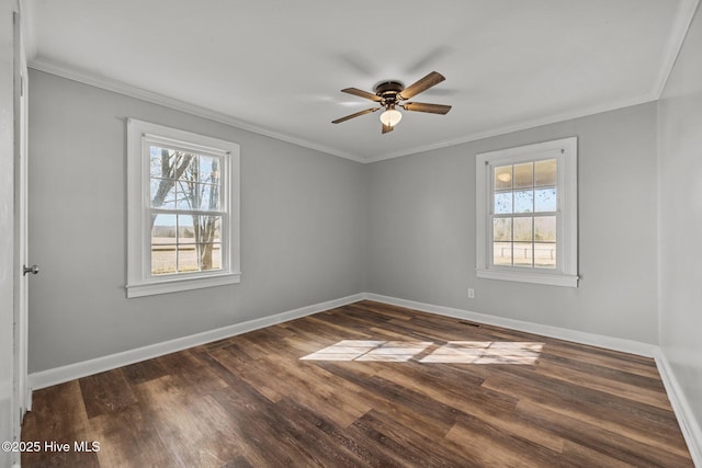 unfurnished room featuring baseboards, wood finished floors, and ornamental molding