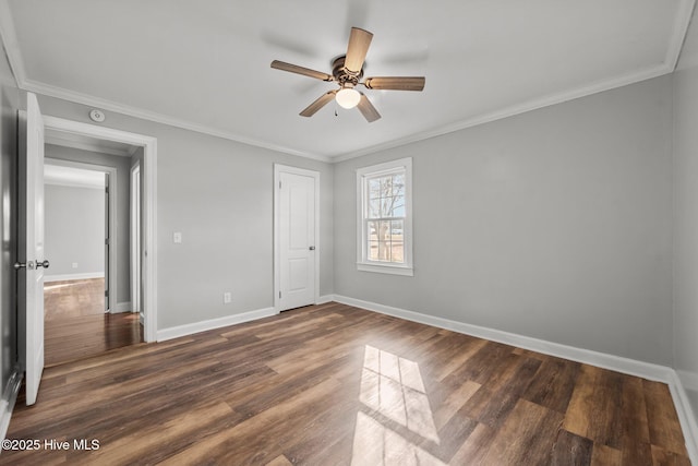 unfurnished bedroom with a ceiling fan, wood finished floors, baseboards, a closet, and crown molding