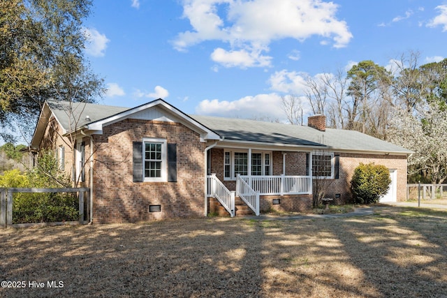 ranch-style home with a porch, an attached garage, crawl space, brick siding, and a chimney