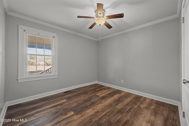 unfurnished room with dark wood finished floors, visible vents, crown molding, and baseboards