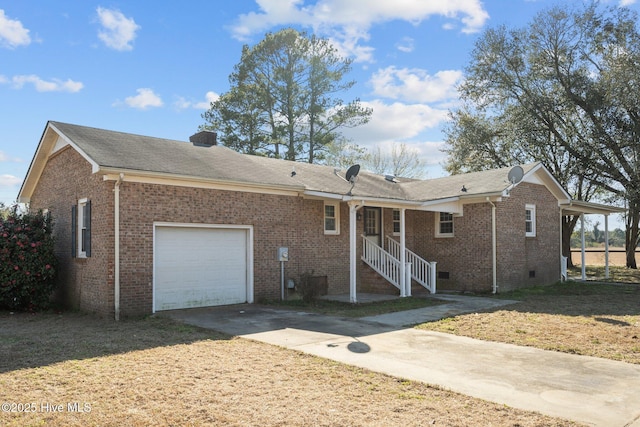 view of front facade featuring brick siding, a chimney, a garage, crawl space, and driveway