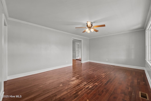 spare room with visible vents, a ceiling fan, dark wood-type flooring, and baseboards