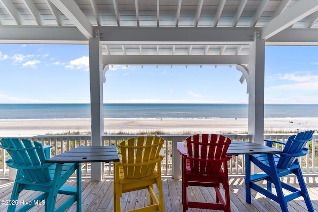 sunroom / solarium with a beach view and a water view