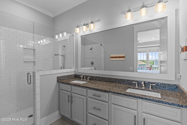 full bath featuring a sink, a stall shower, and double vanity