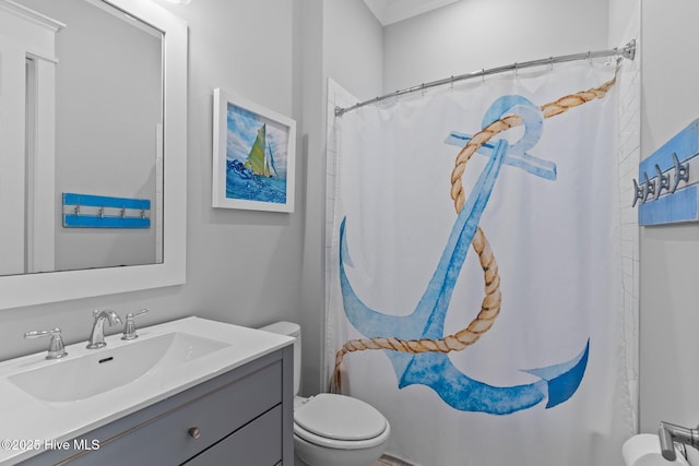 full bathroom featuring vanity, toilet, and curtained shower
