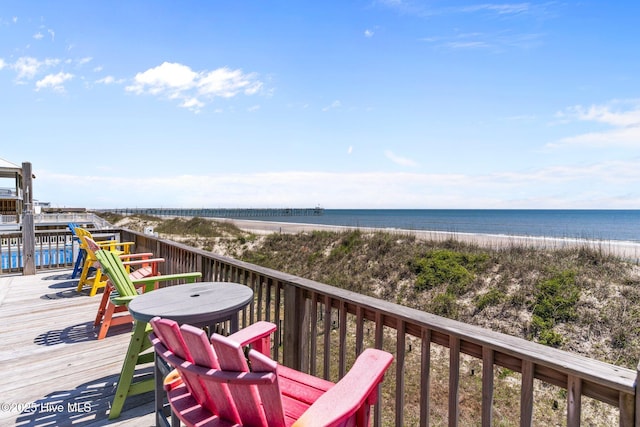 deck with a water view and a beach view
