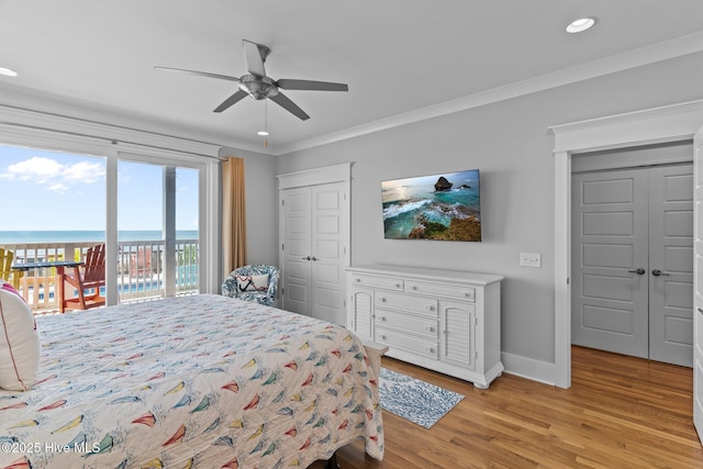 bedroom featuring access to exterior, light wood-style flooring, recessed lighting, baseboards, and ornamental molding