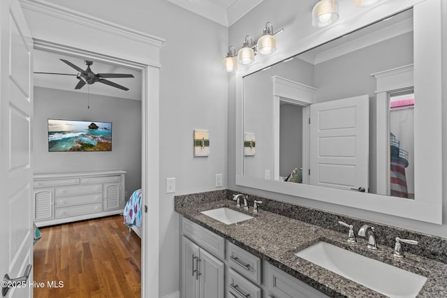 ensuite bathroom featuring ensuite bathroom, a sink, a ceiling fan, and wood finished floors