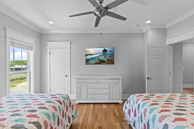bedroom featuring recessed lighting, baseboards, a ceiling fan, wood finished floors, and ornamental molding