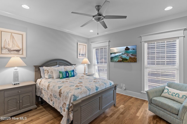 bedroom featuring recessed lighting, ornamental molding, and wood finished floors