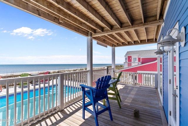 deck featuring a fenced in pool and a water view