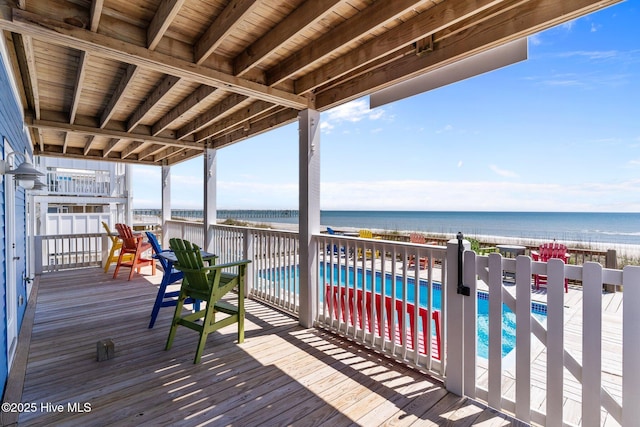 deck with a water view and a fenced in pool