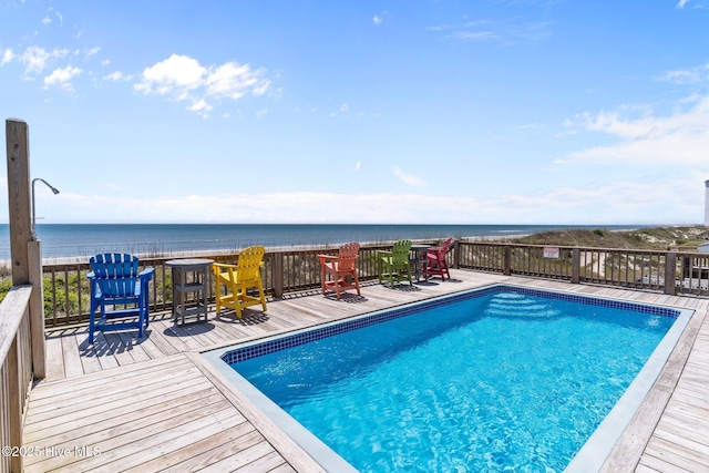 view of swimming pool with a fenced in pool and a deck with water view