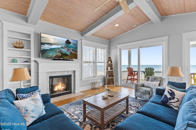 living room featuring visible vents, a fireplace with flush hearth, wood finished floors, wooden ceiling, and lofted ceiling with beams