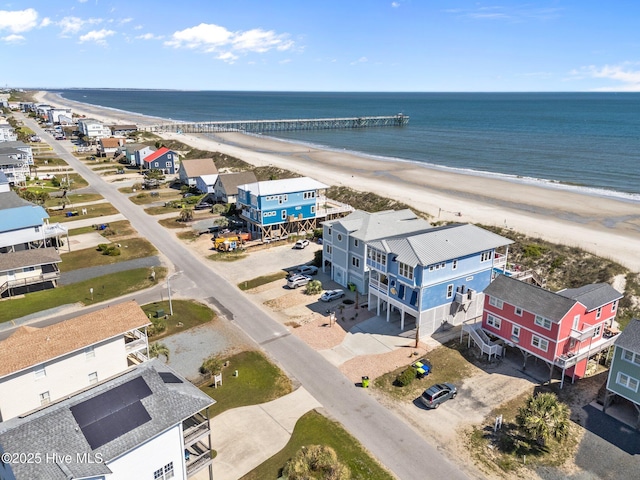 drone / aerial view featuring a water view and a view of the beach