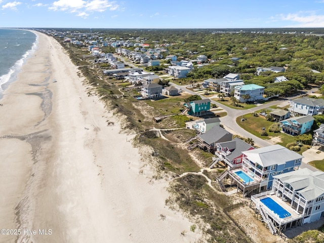 birds eye view of property featuring a water view and a view of the beach