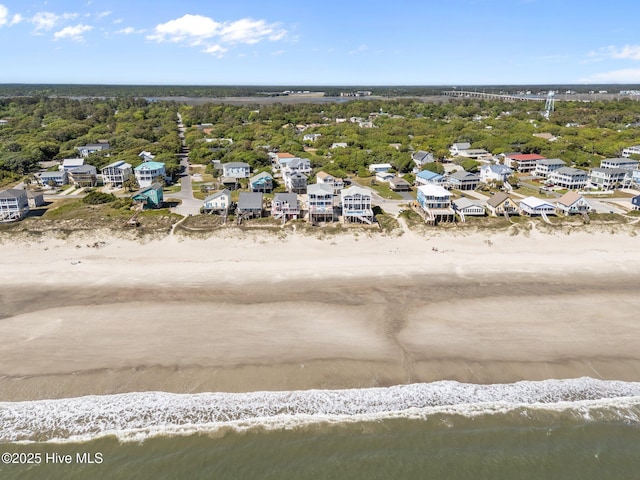 aerial view featuring a water view, a view of the beach, and a residential view