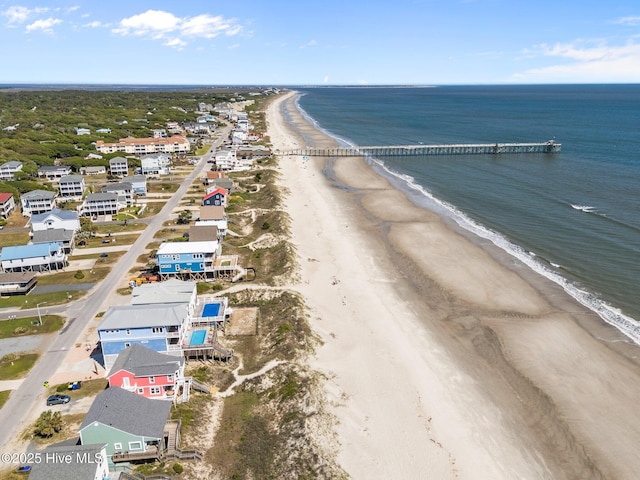 bird's eye view with a water view and a beach view
