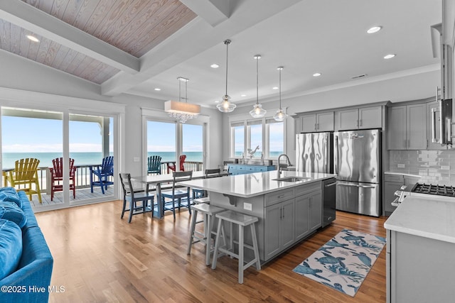 kitchen featuring a sink, light countertops, gray cabinets, and stainless steel appliances