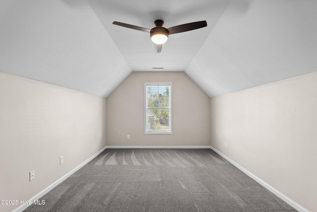 bonus room featuring a ceiling fan, carpet, baseboards, visible vents, and vaulted ceiling