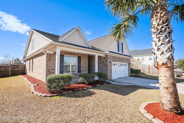 view of front of home featuring brick siding, a shingled roof, a front lawn, fence, and driveway