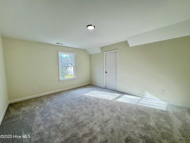 unfurnished room featuring carpet, visible vents, and baseboards