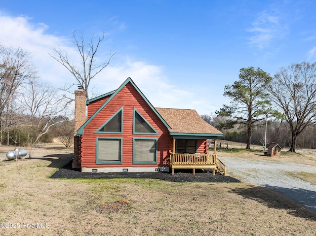 view of front of home featuring log siding, a shingled roof, a chimney, a front lawn, and crawl space