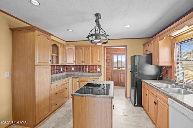 kitchen featuring light brown cabinets, a sink, decorative backsplash, black appliances, and a center island