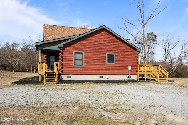 view of home's exterior with crawl space, roof with shingles, and log exterior