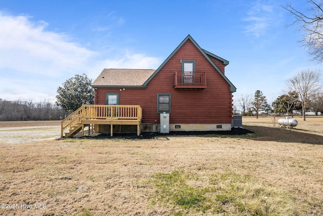 back of property with stairway, log exterior, central AC, a lawn, and crawl space