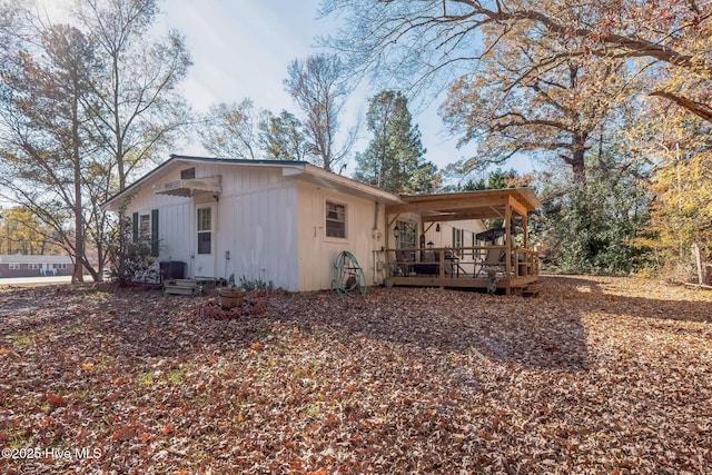 back of house with a wooden deck