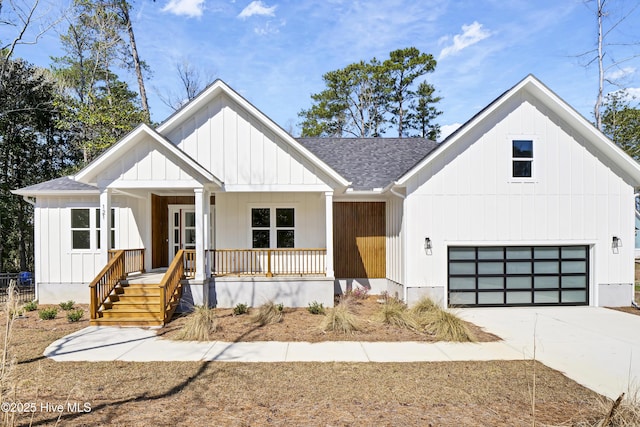 modern inspired farmhouse featuring board and batten siding, a garage, covered porch, and a shingled roof