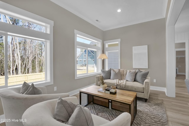 living room with wood finished floors, recessed lighting, a healthy amount of sunlight, and baseboards