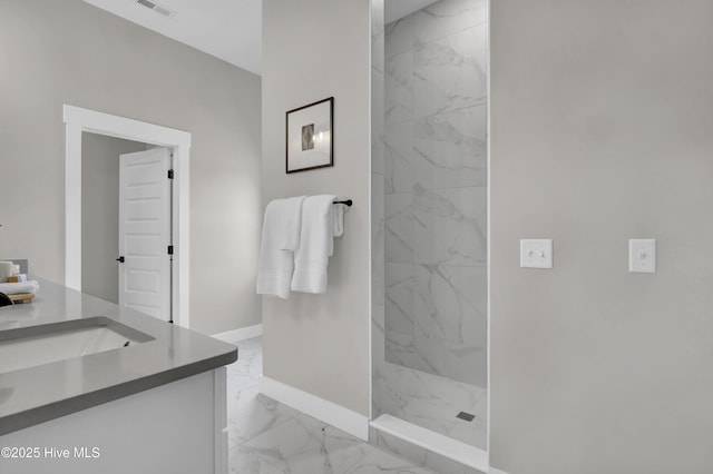 bathroom featuring vanity, visible vents, baseboards, a marble finish shower, and marble finish floor